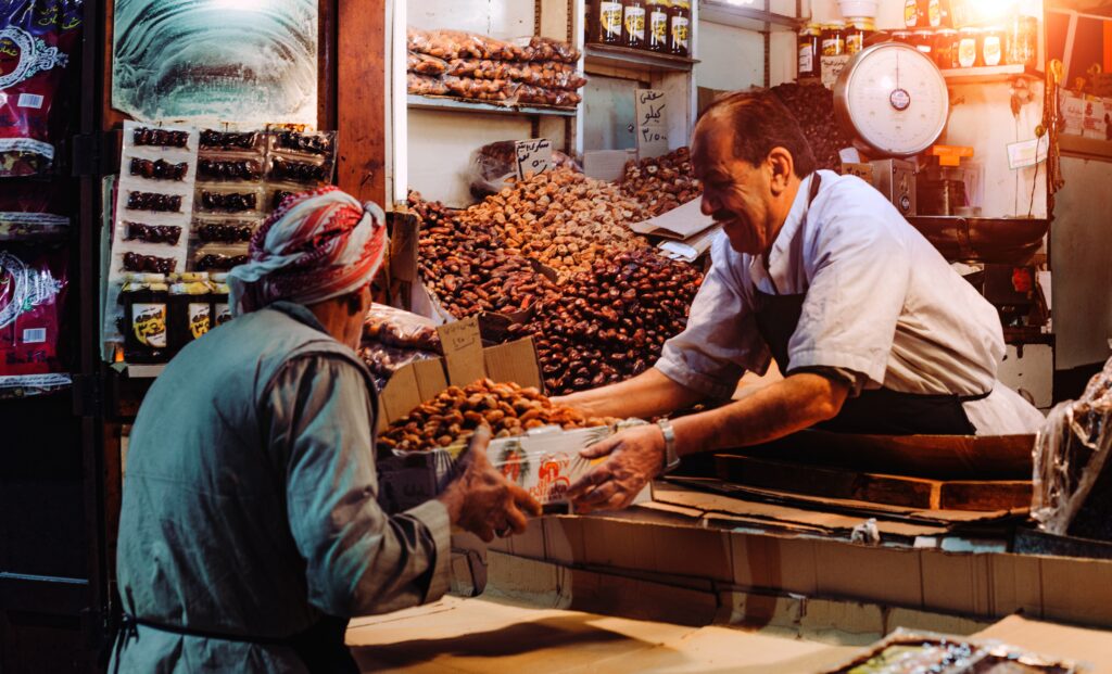 man selling fruits to customer